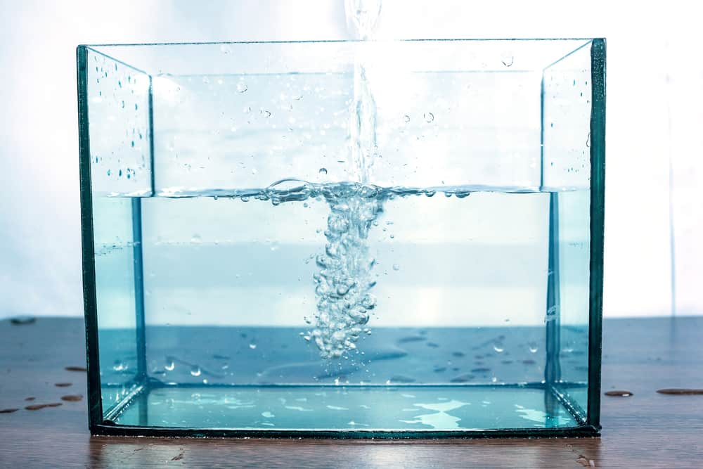 Moving water waves and bubbles bursting in the aquarium